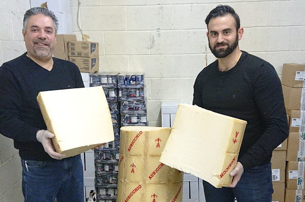 Nicastro owners hold giant blocks of cheese